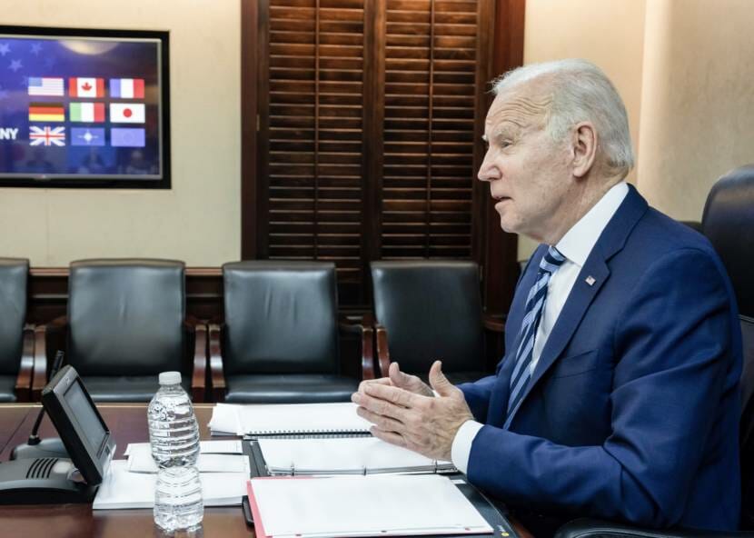 President Joe Biden sitting at a desk, seen in profile