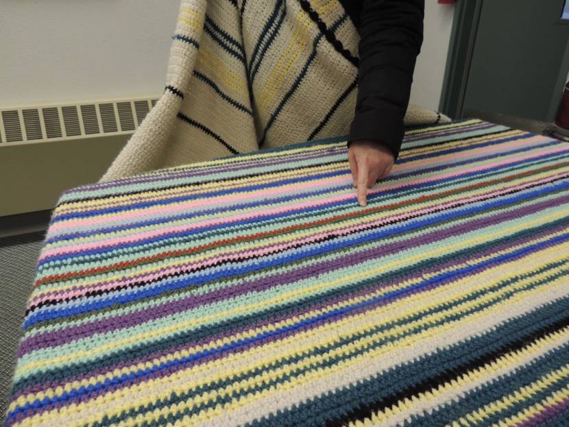 A blanket with stripes of many colors