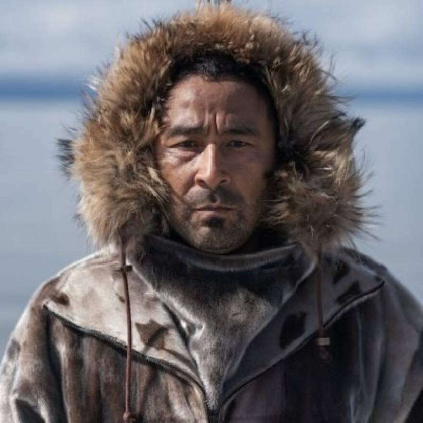 Portrait of a man in a parka, standing outside