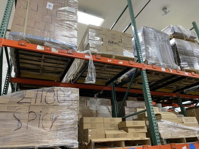 Boxes are marked with the word "collapse" at the main Barnacle Foods warehouse in Lemon Creek. 