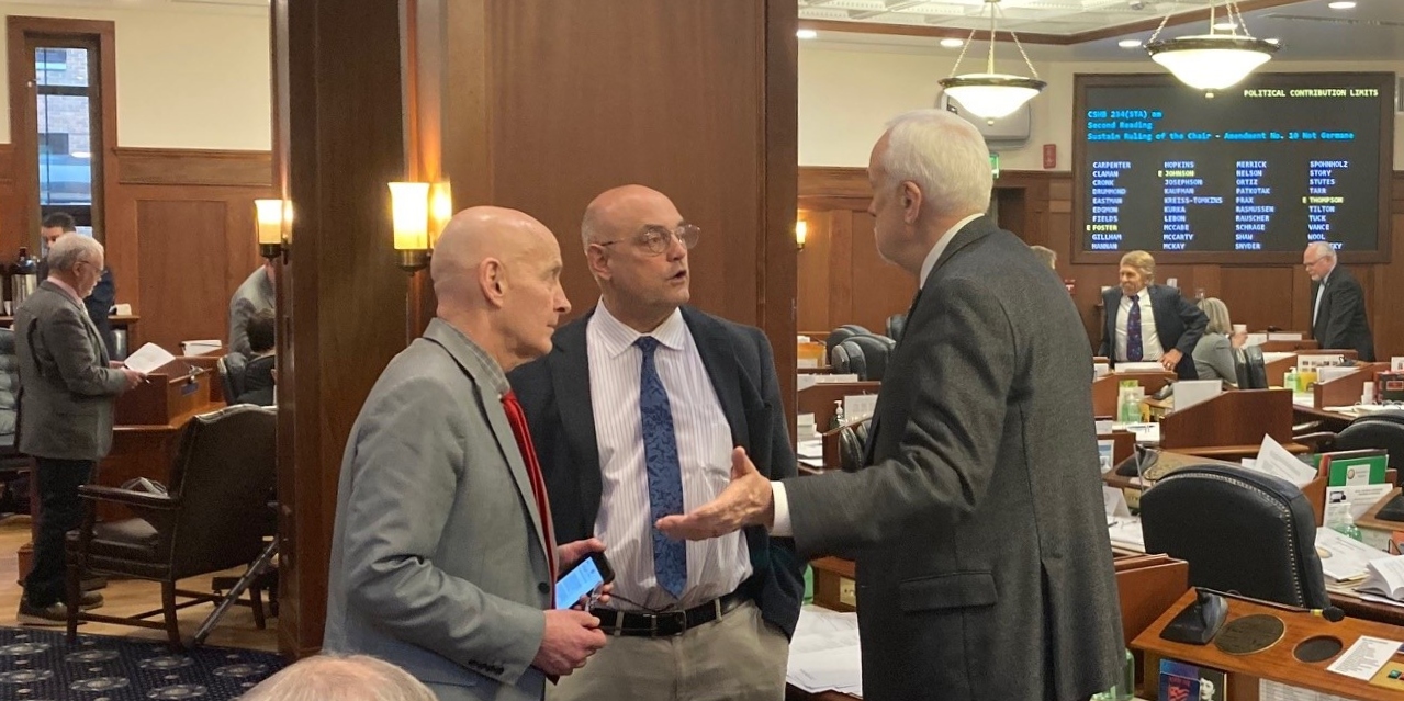 Reps. Dan Ortiz, I-Ketchikan; Andy Josephson, D-Anchorage; and Bart LeBon, R-Fairbanks, talk during a break on March 14, 2022, in the Alaska State Capitol in Juneau, Alaska. The Alaska House of Representatives was considering amendments to House Bill 234, which would reinstitute limits on campaign contributions in the state. (Photo by Andrew Kitchenman/KTOO and Alaska Public Media)