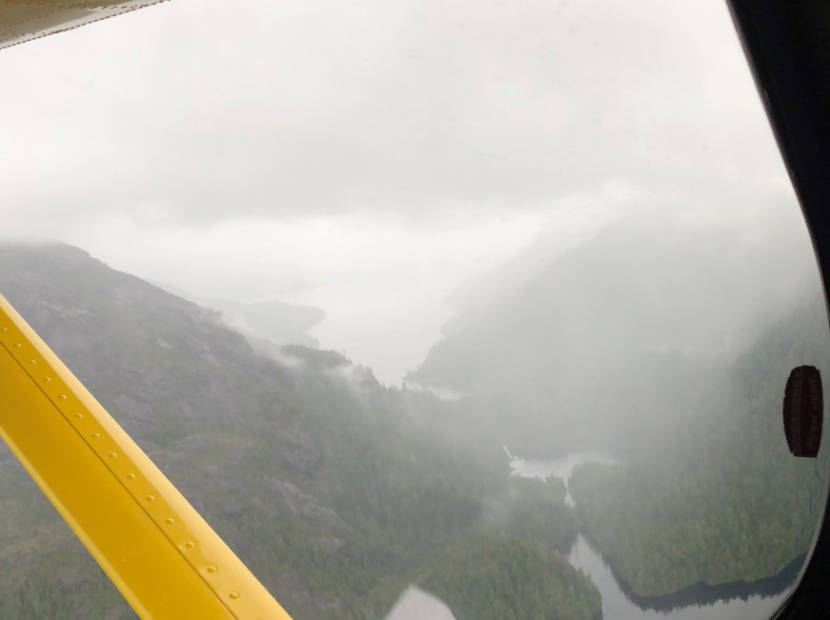 A view from a plane of steep slopes, with poor visibility