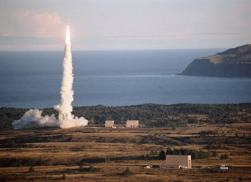 A rocket lifting off from a coastal launch pad
