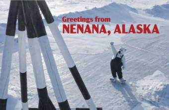 A man in a polar bear suit, dwarfed by a giant tripod on river ice