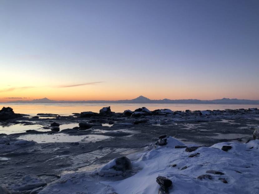 Ice and rocks along the shore of Cook Inlet at sun
