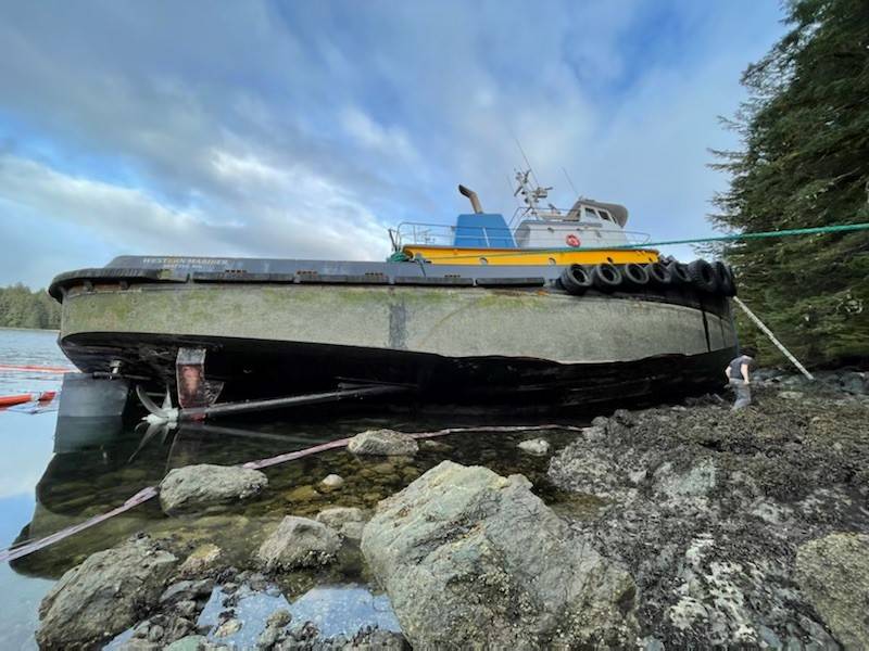 A tugboat stranded on a rocky beach