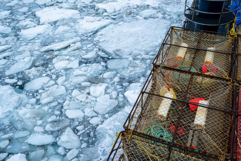 A crab boat moving through icy seas