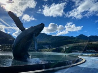 The Douglas Bridge is seen behind the whale statue in Juneau in September 2021.