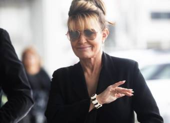 Sarah Palin, walking with sunglasses on