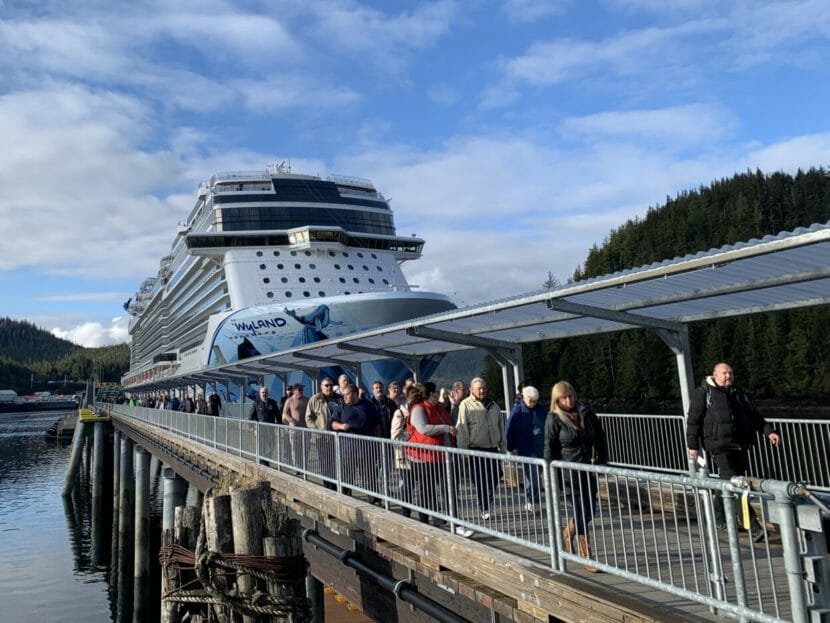 Passengers leaving a large cruise ship
