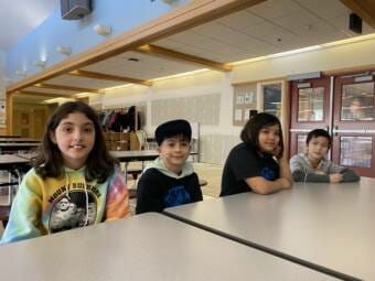 Fourth grade students Amelia Ryder, Kayden Manacio, Alania Celler and Klarence Domingo sit in the cafeteria at Riverbend Elementary School on April, 4 2022. 
