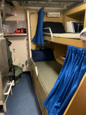 Bunk beds inside a very small ship's cabin