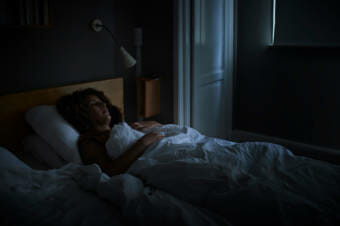 A person sleeping in a dimly lit room