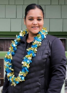 A woman wearing a blue-and-gold candy lei