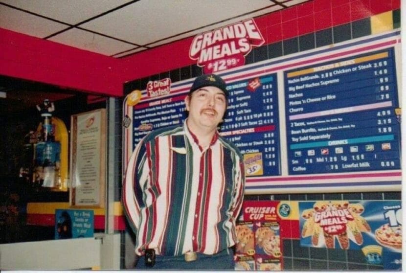 Charles McKenry poses in front of the menu at Juneau's downtown Taco Bell in 1999.
