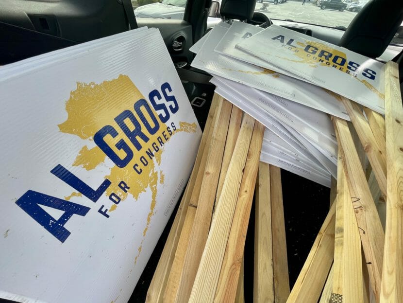 A pile of Al Gross campaign signs in the back of a car
