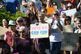 People holding signs at a pro-choice rally