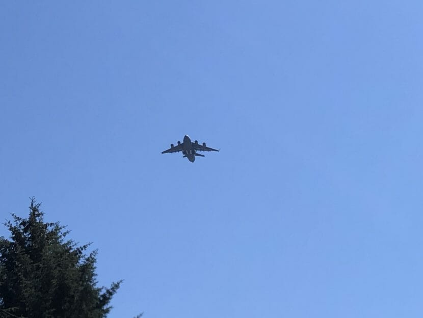 A large military transport plane flying overhead