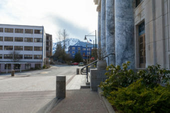 The entrance of the Alaska capitol with a mountain in the background