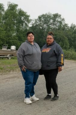 Two women standing in a road