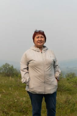 A portrait of a woman standing outside under very smoky skies