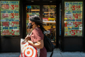 A woman walking down a street carrying a Target shopping bag