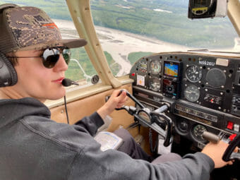 A young pilot in a plane in the air
