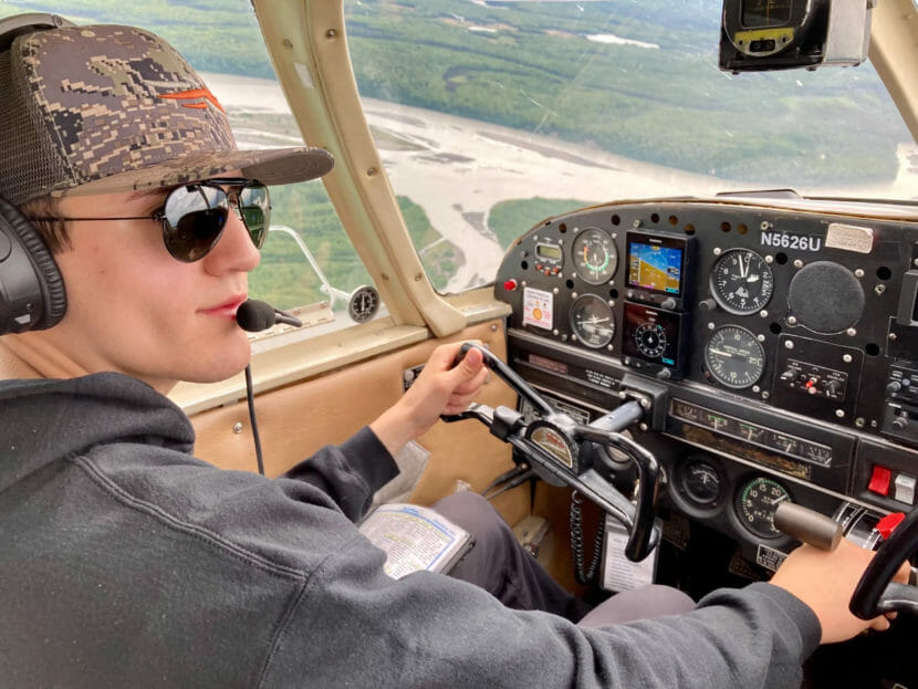 A young pilot in a plane in the air