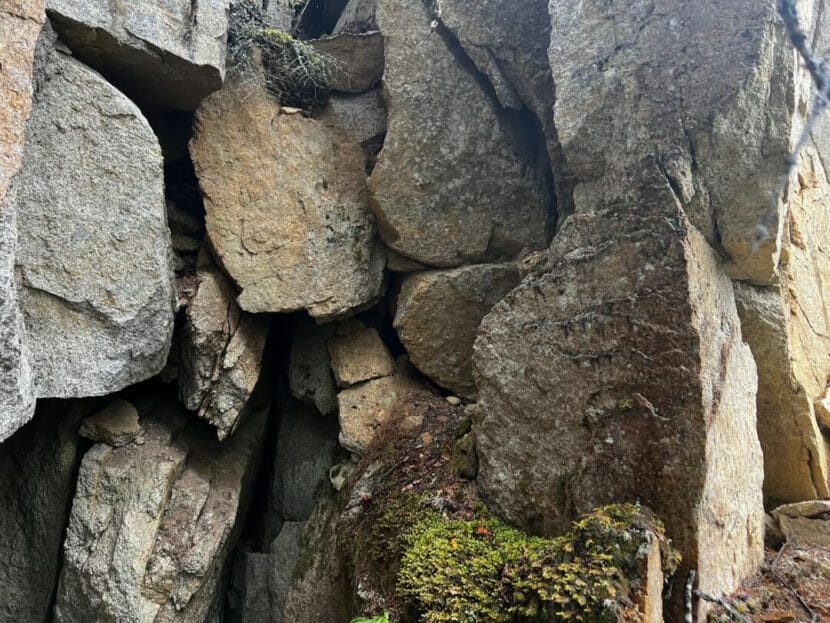 A vertical jumble of gray boulders