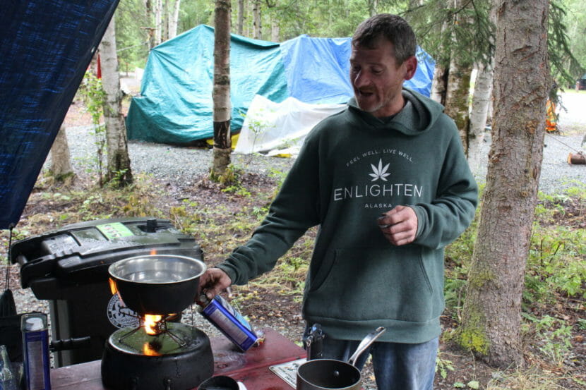 A man cooking in a campground