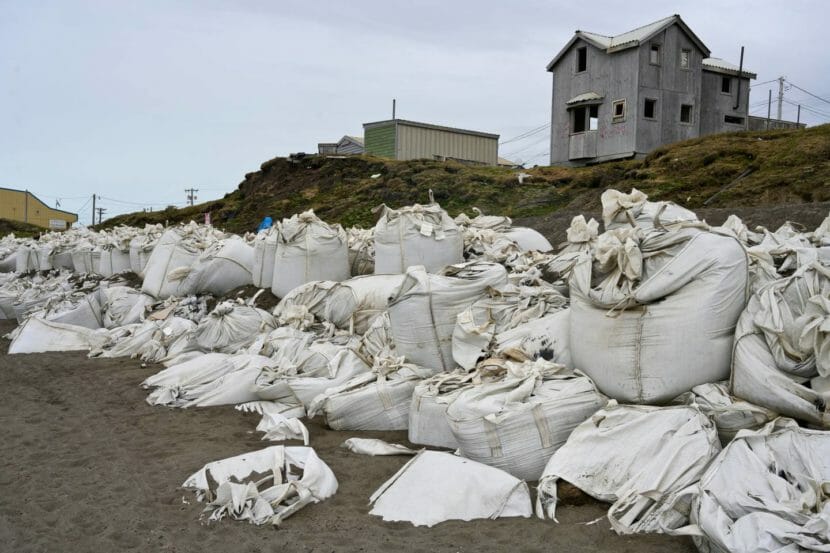 A long row of sandbags piled up along a beach