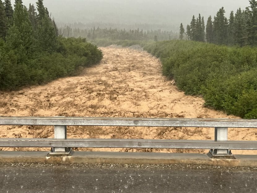 A brown, raging creek seen from a bridge