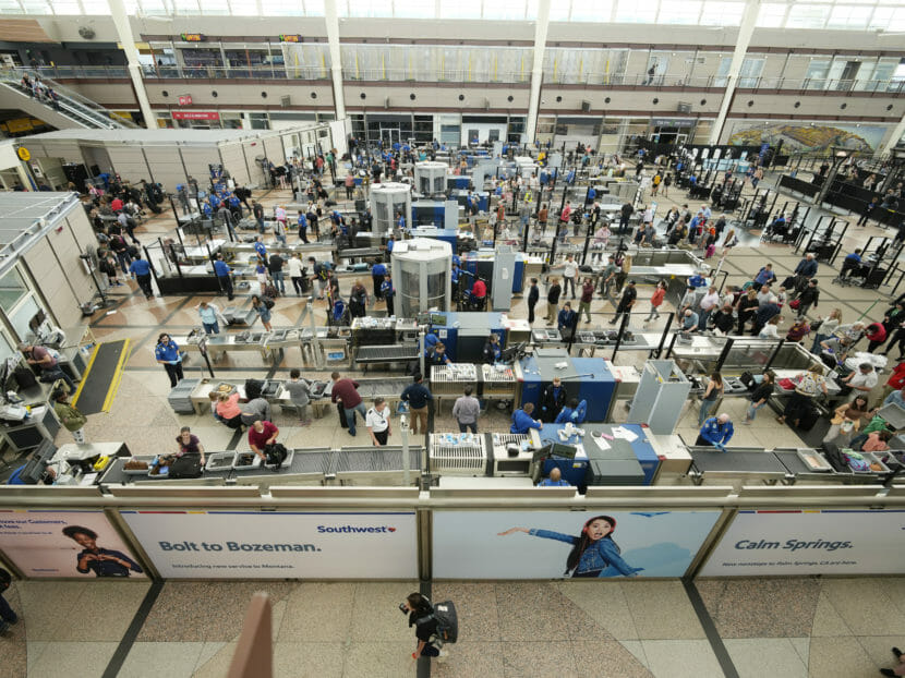 Passengers in Denver's cattle-pen-style check-in hall