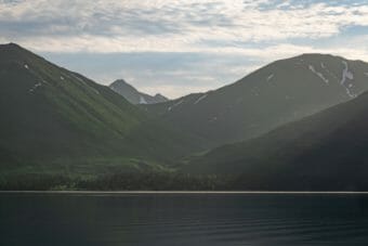 Looking across a placid lake at mountains on the far shore