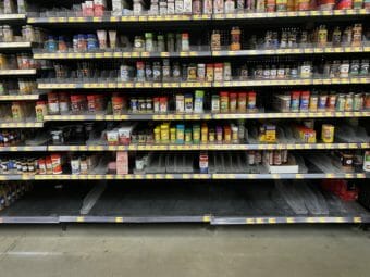 Grocery store shelves with numerous spices missing and no salt at all