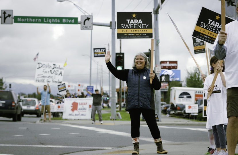 Tara Sweeney and supporters wave campaign signs by and Anchorage street