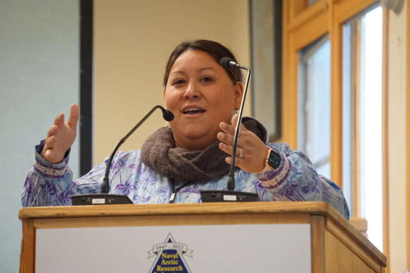 A woman speaks from behind a lectern