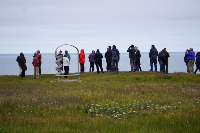 A group of people standing by the shore