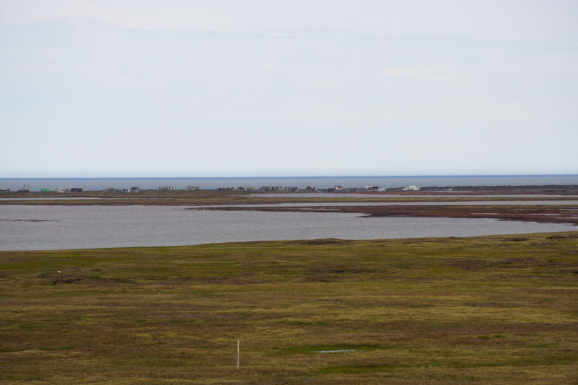 Open tundra and coastline with Utqiagvik in the distance