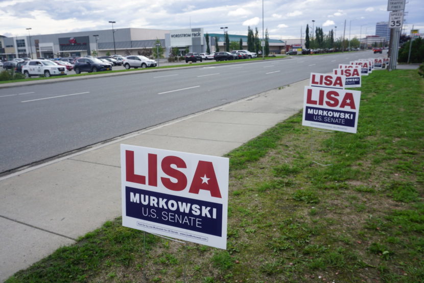 Lisa Murkowski yard signs along a city sidewalk