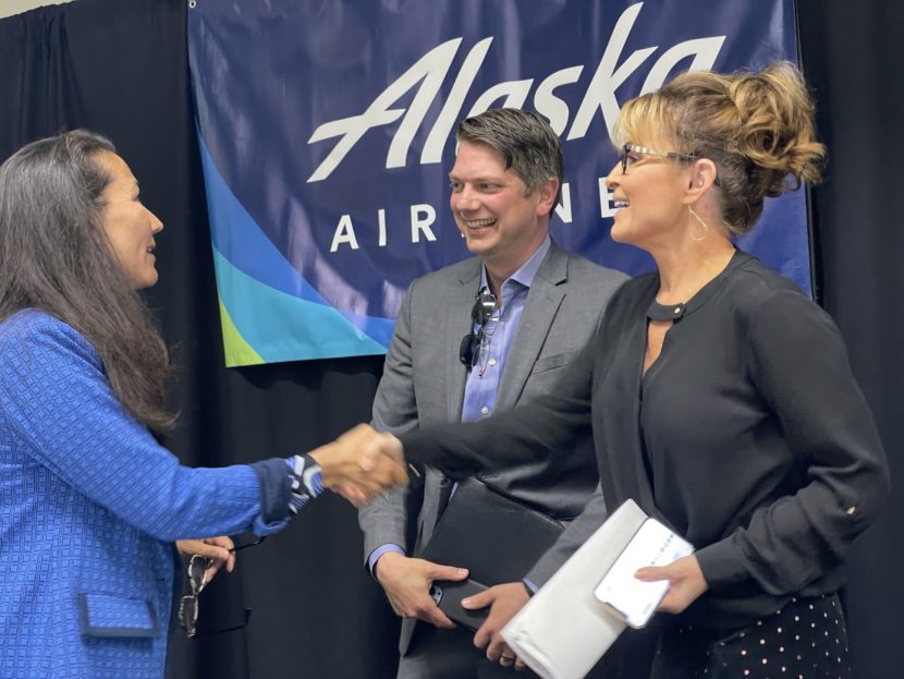 Sarah Palin stands next to Nick Begich while shaking Mary Peltola's hand