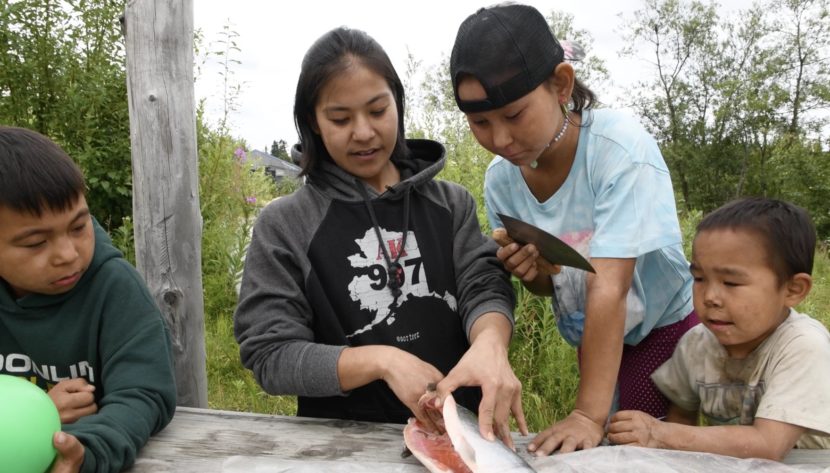 Children cutting salmon