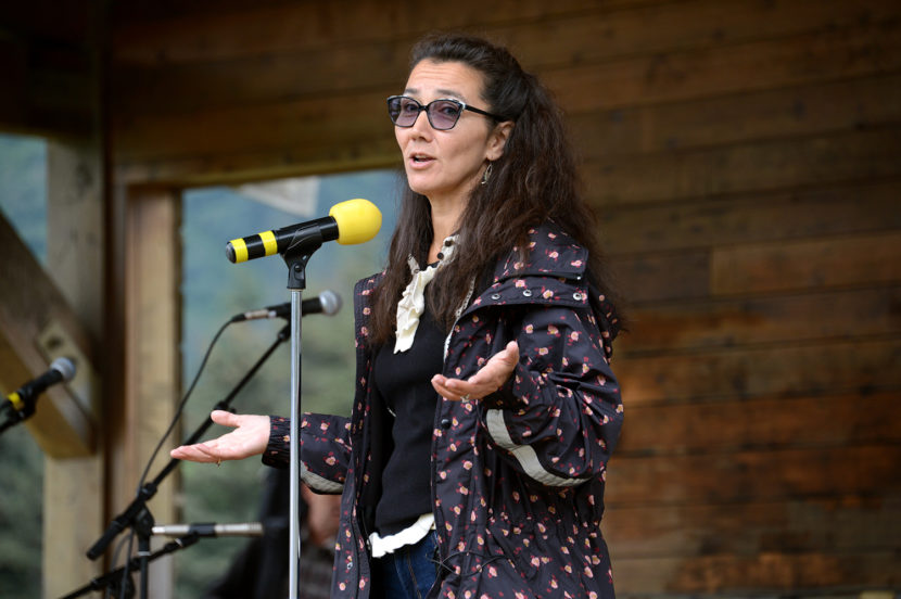 Mary Peltola gestures while speaking into a microphone