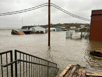 A photo of a coastal area showing several flooded buildings