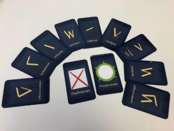 A set of dark blue cards with symbols printed on them arranged in an arc