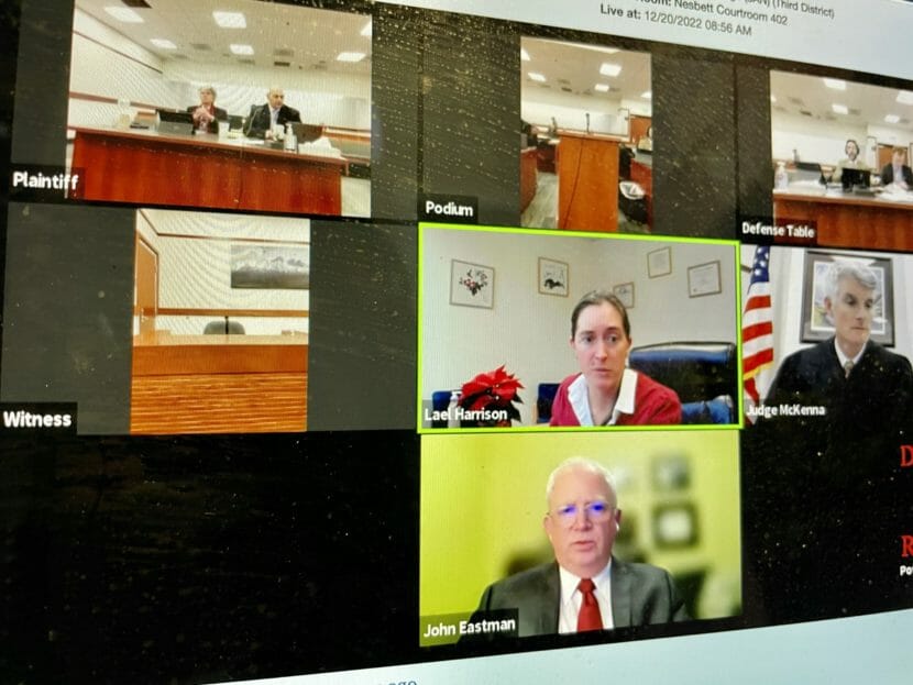 An image of a computer screen showing a mosaic of images of people involved in the trial.