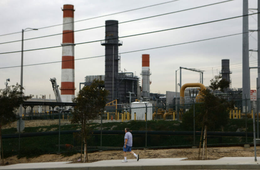A man walking by a power plant