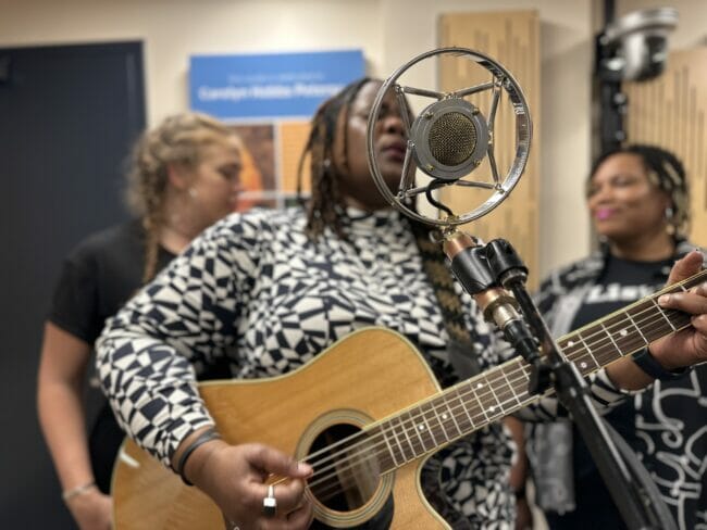 Kyshona performing on the microphone dedicated to Bill Legere <i>(Photo by Taylor VIdic)</i>
