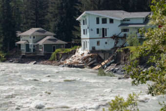 Houses on River Drive in Juneau, Alaska partially collapsed into to the Mendenhall River during record high water following a glacial outburst flood on Saturday August 5th, 2023. (Mikko Wilson / KTOO)