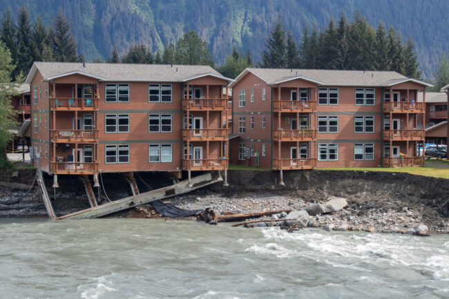Condos at 4410 Riverside Drive overhang the Mendenhall River Sunday after following a glacial outburst flood on Saturday August 5th, 2023. (Mikko Wilson / KTOO)